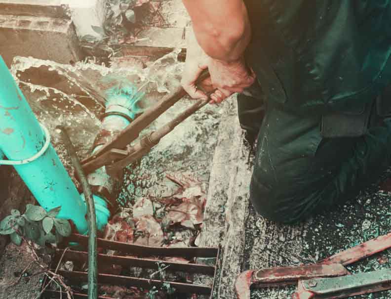 plumber working repair the broken pipe with Adjustable Wrenches plumber working repair the broken pipe with Adjustable Wrenches or Locking Pliers in hole ditch at roadside and water Motion