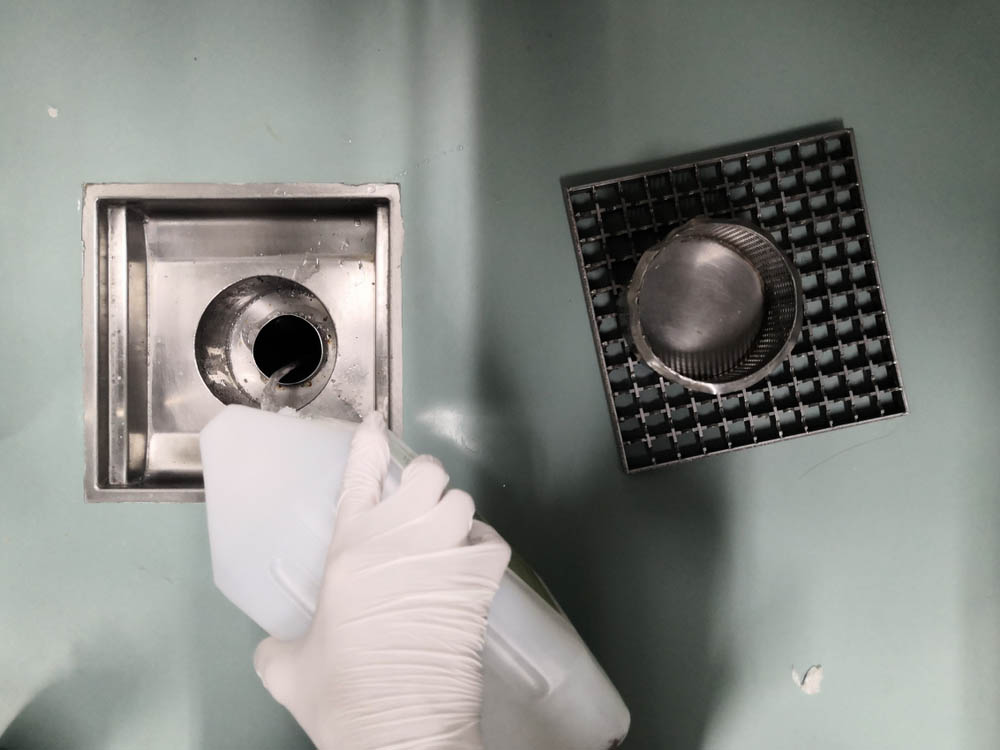 Chemical cleaner being poured down the drain