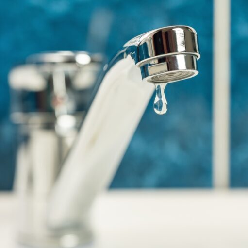 A drop of water drips from a leaky faucet.