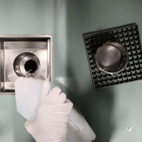 Chemical cleaner being poured down the drain
