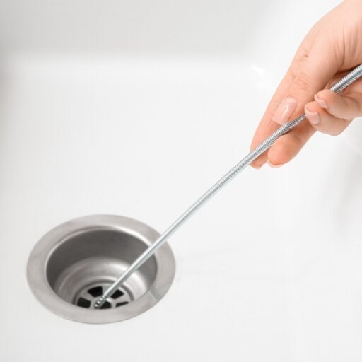 inserting drain snake into sink