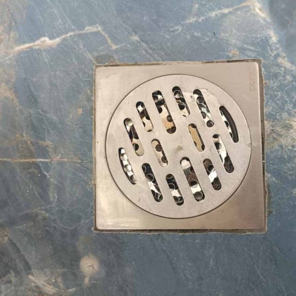 a person installing a drain screen