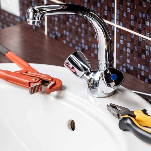 Plumber replacing a faucet in a sink