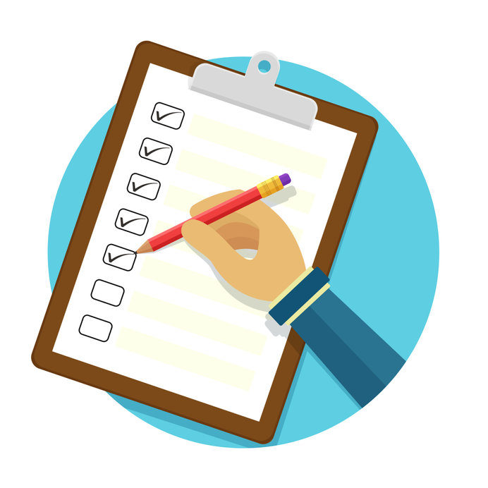 Hand holding clipboard with checklist and pencil