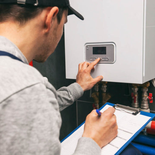technician inspecting a water heater